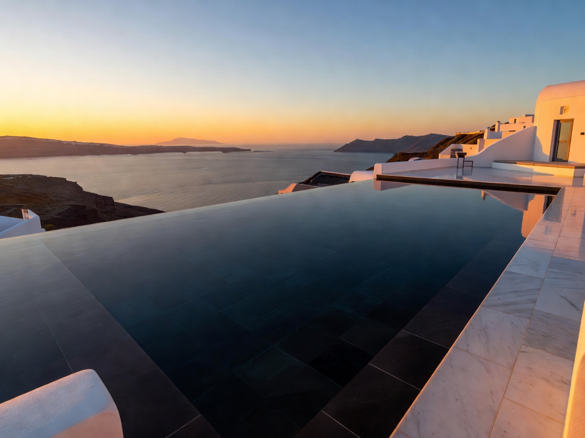 Canaves Oia Epitome oversized black-tiled infinity pool facing the western Aegean sea horizon